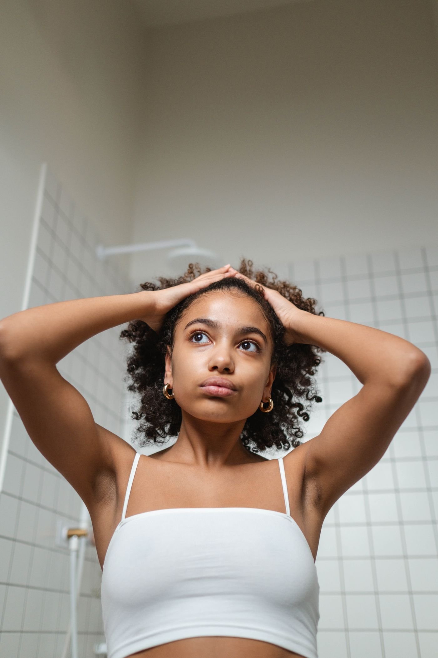 Woman shaping her natural curls after wash day