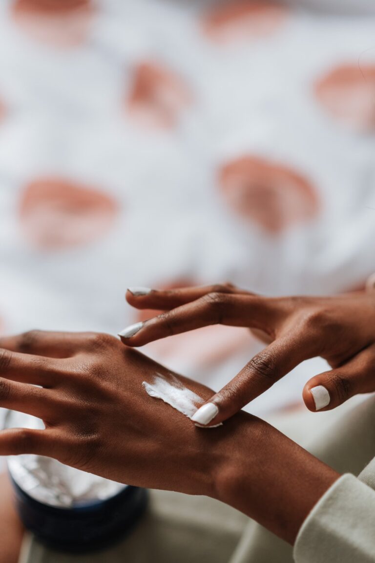 Woman applying body lotion
