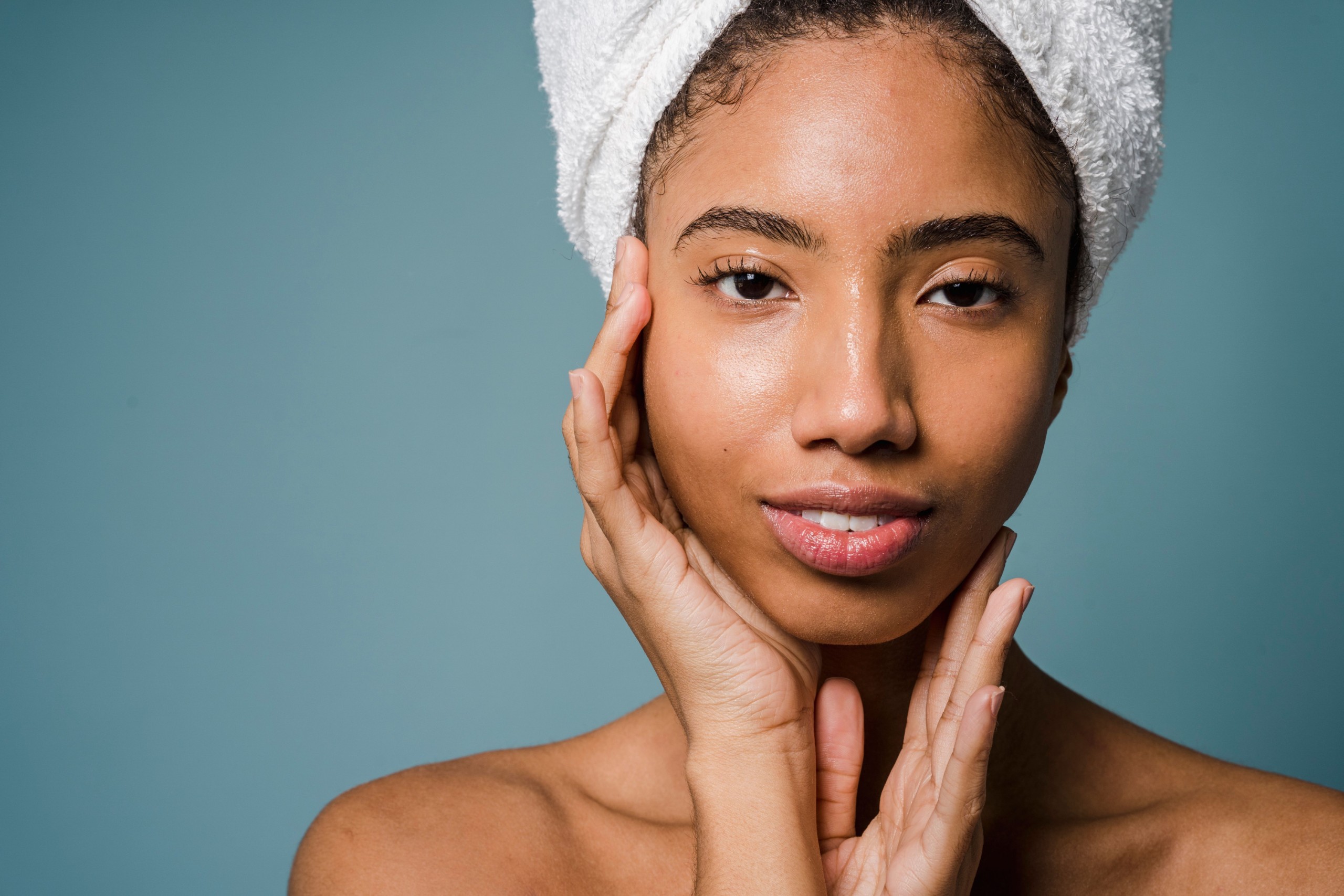 Woman with a towel wrap and glowing skin