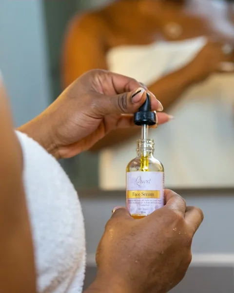 Hands holding a body oil bottle