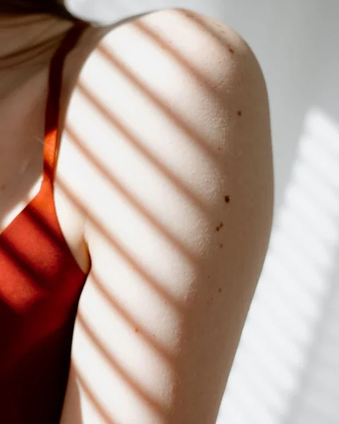Sunlight and shadow on skin, sunscreen